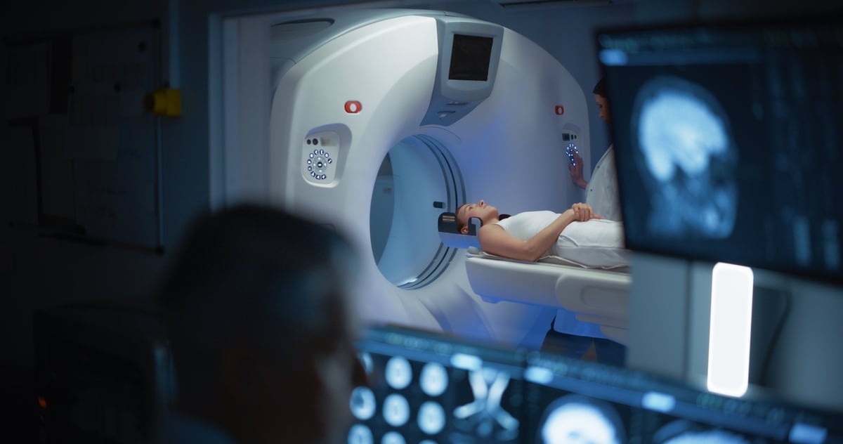 A doctor monitoring brain scans in a medical control room
