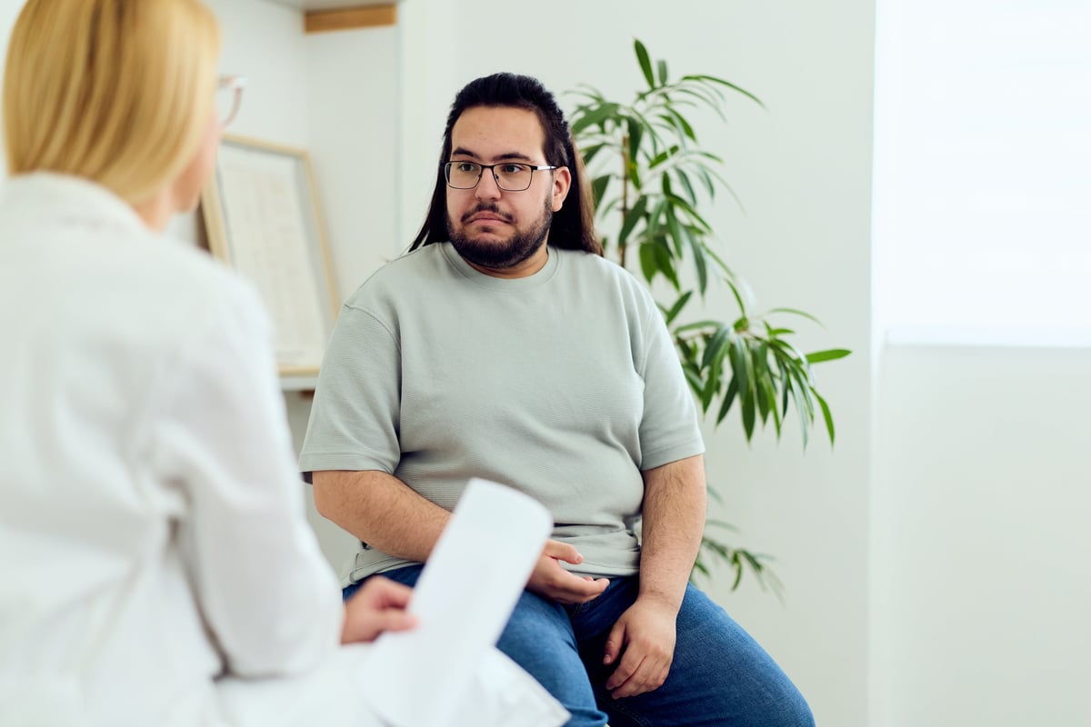 A physician consulting with a patient in a bright, modern medical office